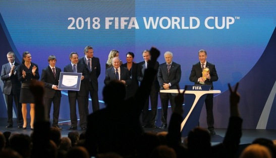 Audience members react as Russia's Deputy Prime Minister Igor Shuvalov (R) holds the World Cup trophy after Russia was chosen to host the 2018 World Cup at the FIFA headquarters in Zurich on December 2, 2010. Russia was awarded the 2018 World Cup after an acrimonious bidding war marred by allegations of corruption and illegal deal-making. AFP PHOTO/KARIM JAAFAR (Photo credit should read KARIM JAAFAR/AFP/Getty Images)